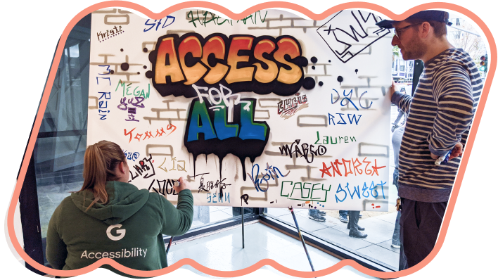Image of two Googlers from the Accessibility team, tagging their names on board with graffiti art that says, "Access for All"